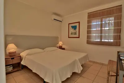 a bedroom with a white bed and a window at Casa Vale Do Lobo 32 Charming 2 Bedroom Townhouse Close To Beach in Vale do Lobo