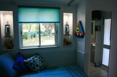 a blue room with a window and a blue couch at Amazing Algarve - Albufeira in Albufeira