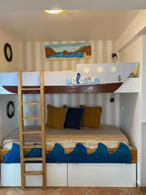 a bunk bed in a room with a ladder at Amazing Algarve - Albufeira in Albufeira