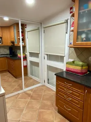 a kitchen with two sliding glass doors in a room at Amazing Algarve - Albufeira in Albufeira