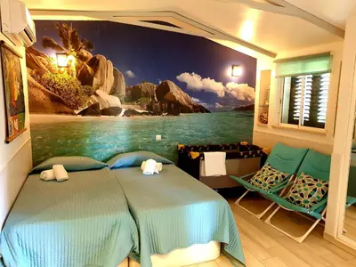 a bedroom with a bed with a painting on the wall at Amazing Algarve - Albufeira in Albufeira