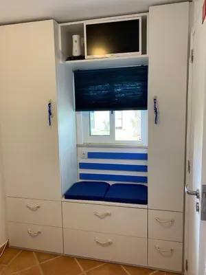 a room with white cabinets with a tv and a window at Amazing Algarve - Albufeira in Albufeira