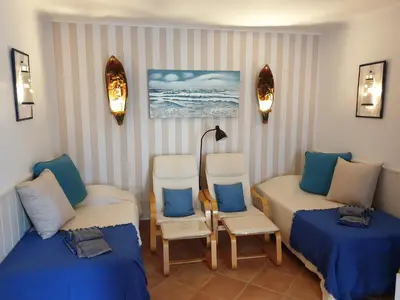 a room with two beds and two chairs and a lamp at Amazing Algarve - Albufeira in Albufeira