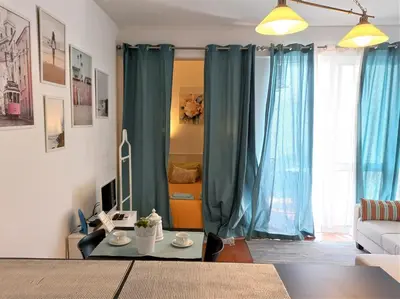 a living room with blue curtains and a couch at Apartament near the ocean in Albufeira