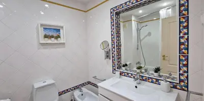 a bathroom with a sink and a toilet and a mirror at Praia Oura Sunset in Albufeira