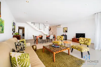 a living room with a couch and chairs and a table at Villas Rocha in Albufeira