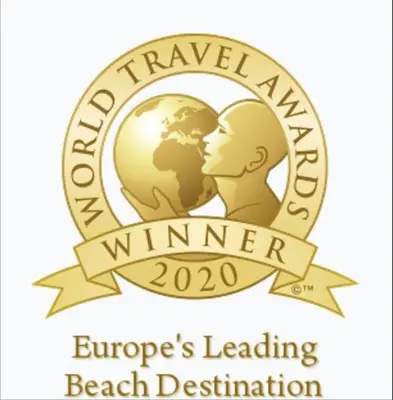 a logo for the durham travel agency winner beach destination at Villas Rocha in Albufeira