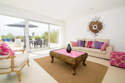 a living room with a couch and a table at Villas Rocha in Albufeira