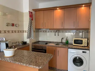 a kitchen with a sink and a washing machine at Apartamento 806 in Albufeira