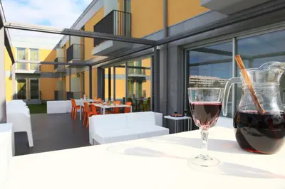 a glass of red wine sitting on a table at Hotel 3K Faro Aeroporto in Faro