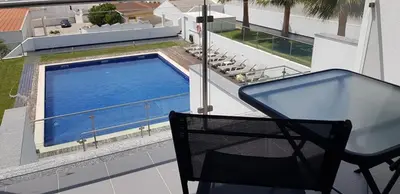a balcony with a swimming pool on a house at 