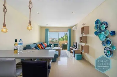 a living room with a couch and blue balloons at Medronheira B2 - Dream Lodging in Albufeira