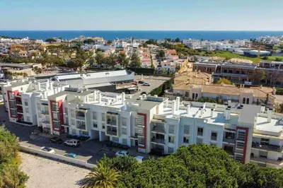 an aerial view of a city with buildings and the ocean at Medronheira B2 - Dream Lodging in Albufeira
