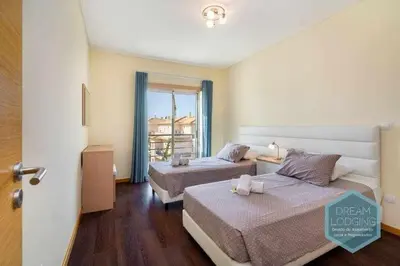 a hotel room with two beds and a window at Medronheira B2 - Dream Lodging in Albufeira