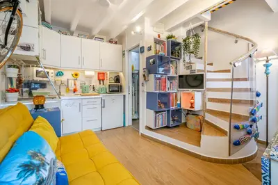 a childs room with a play kitchen with a slide at Casinha da Ti Babel in Faro