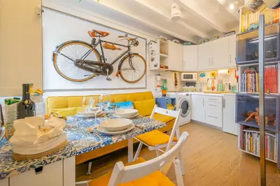 a bike hanging on the wall in a kitchen at Casinha da Ti Babel in Faro