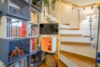 a room with a blue book shelf with books at Casinha da Ti Babel in Faro
