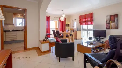 a living room with a kitchen and a dining room at Greice Homes-Luxury 2 bed en-suite south facing & Golf view in Quarteira