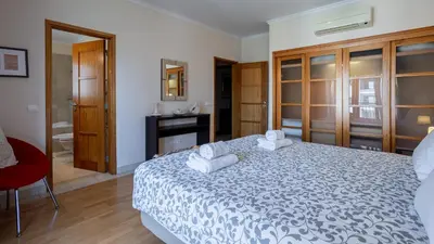a bedroom with a bed with towels on it at Greice Homes-Luxury 2 bed en-suite south facing & Golf view in Quarteira