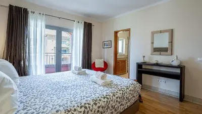 a bedroom with a bed with towels on it at Greice Homes-Luxury 2 bed en-suite south facing & Golf view in Quarteira