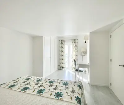 a white bedroom with a bed and a window at Sunset Marina - Sea view - Vilamoura in Vilamoura