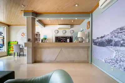 a lobby with a bar in the center of a building at Bellavista Avenida By BeGuest in Albufeira