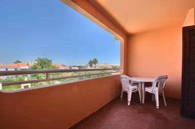a bedroom with a bed and a desk with a chair at Bellavista Avenida By BeGuest in Albufeira