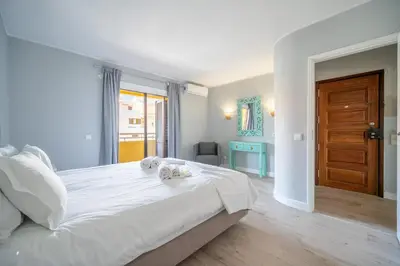 a bedroom with a large white bed with towels on it at Bellavista Avenida By BeGuest in Albufeira