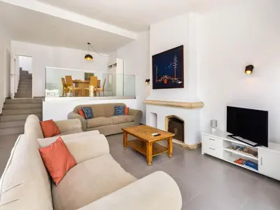 a living room with a couch and a fireplace at Villa Oceano Golf 482 2 Bedrooms Sea Views A Stone's Throw To The Beach in Vale do Lobo
