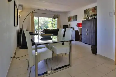 a dining room with a glass table and white chairs at Charming Vale Do Lobo Villa Casa Vale Do Lobo 832A 3 Bedrooms in Vale do Lobo