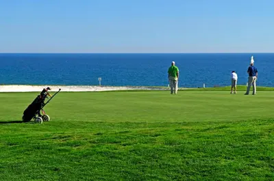 a group of people playing golf near the ocean at Charming Vale Do Lobo Villa Casa Vale Do Lobo 832A 3 Bedrooms in Vale do Lobo