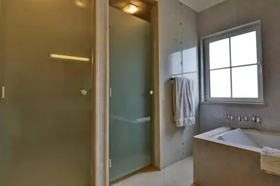 a bathroom with a shower and a tub and a sink at Villa Varandas Do Lago 5 Bedroom Villa Private Pool Table Tennis in Vale do Lobo