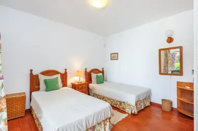 a bedroom with two beds and a mirror at Villa Quadradinhos 38Q 4 Bedrooms Private Pool Short Walk To The Beach in Vale do Lobo