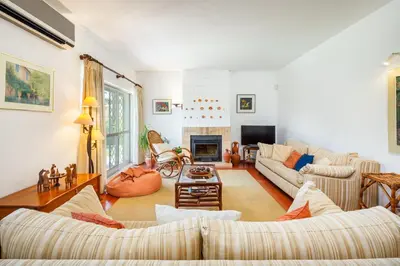 a living room with couches and a fireplace at Villa Quadradinhos 38Q 4 Bedrooms Private Pool Short Walk To The Beach in Vale do Lobo