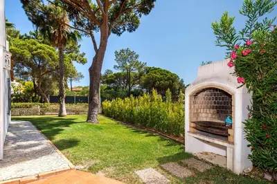 a garden with a fireplace in a yard at Villa Vale Do Lobo 626 3 Bedrooms Private Pool Short Walk To The Praca in Vale do Lobo