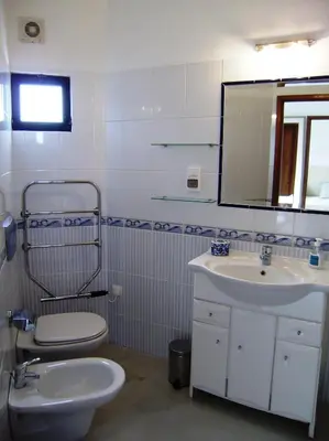 a bathroom with a toilet and a sink and a mirror at Villa Vale Do Lobo 2 Townhouse 3 Bedroom Close To Amenities And Beach in Vale do Lobo