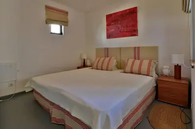 a bedroom with a large white bed with two pillows at Villa Vale Do Lobo 2 Townhouse 3 Bedroom Close To Amenities And Beach in Vale do Lobo