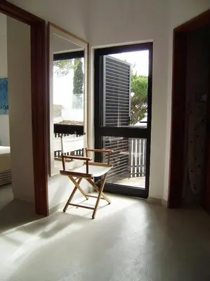 a room with a chair and a large window at Villa Vale Do Lobo 2 Townhouse 3 Bedroom Close To Amenities And Beach in Vale do Lobo