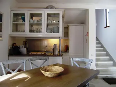 a kitchen with a table and chairs and a staircase at Villa Vale Do Lobo 2 Townhouse 3 Bedroom Close To Amenities And Beach in Vale do Lobo