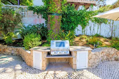 a microwave sitting on a table in a garden at Charming Vale Do Lobo Villa Private Pool Villa Vale Do Garro 51 in Vale do Lobo