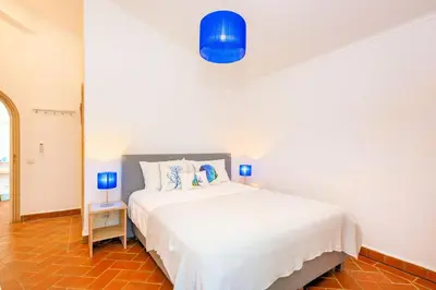 a bedroom with a large white bed with blue lamps at Charming Vale Do Lobo Villa Private Pool Villa Vale Do Garro 51 in Vale do Lobo