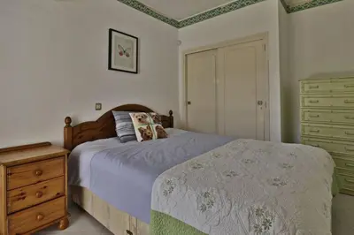 a bedroom with a bed and a wooden dresser at Villa Quadradinhos 21Q 4 Bedroooms Private Pool Vale Do Lobo in Vale do Lobo
