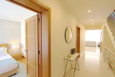 a bedroom with a bed and a mirror on the wall at Villa Casa da Luz, Palmyra 173 - Clever Details in Vilamoura
