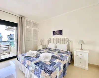 a bedroom with a bed with two towels on it at Tália XI - Near the beach - Vilamoura in Vilamoura