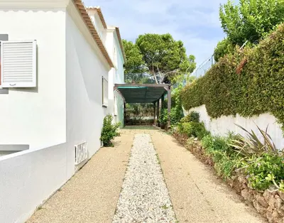 an alley between two white buildings at Vila Pereira - Private Pool - Vilamoura in Vilamoura