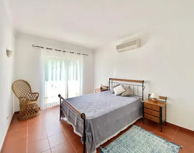 a bedroom with a bed and a window at Vila Pereira - Private Pool - Vilamoura in Vilamoura