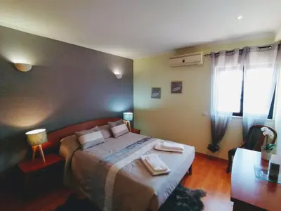 a bedroom with a bed with two towels on it at Bel Appartement 2 chambres au cœur d’Albufeira, proche de la magnifique plage de Oura et des loisirs in Albufeira