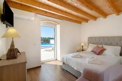 a bedroom with a bed and a view of a pool at Villa Rodrigues Apartment I in Boliqueime