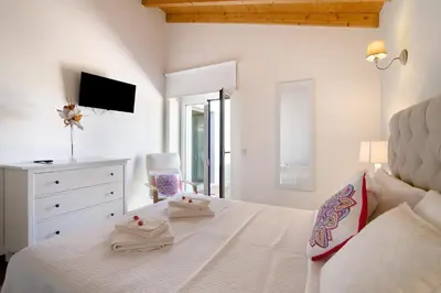 a hotel room with two beds and a mirror at Villa Rodrigues Apartment I in Boliqueime