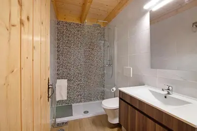a hotel room with two beds and a chair at Villa Rodrigues Apartment I in Boliqueime